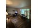Cozy living room featuring hardwood floors, comfortable sofas, and ample natural light at 9550 N Delaware St, Indianapolis, IN 46240