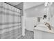 Bathroom featuring double vanity, updated fixtures, and black and white tile floors at 10174 N County Road 471 E, Pittsboro, IN 46167