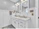 Bathroom featuring double vanity, updated fixtures, and black and white tile floors at 10174 N County Road 471 E, Pittsboro, IN 46167