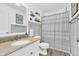 Well-lit bathroom featuring a granite countertop vanity, a towel rack, and a shower with a curtain at 10174 N County Road 471 E, Pittsboro, IN 46167