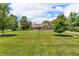 Well-maintained brick home with manicured lawn and mature trees at 10174 N County Road 471 E, Pittsboro, IN 46167