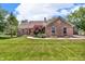 Brick ranch style home with a well-maintained lawn and a walkway leading to the front door at 10174 N County Road 471 E, Pittsboro, IN 46167