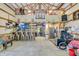 Large garage with exposed beams, bar and seating, basketball hoop, lighting, and ceiling fan at 10174 N County Road 471 E, Pittsboro, IN 46167