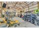 Spacious garage with high ceilings, exposed beams, a bar area, and multiple recreational vehicles at 10174 N County Road 471 E, Pittsboro, IN 46167
