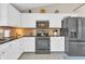 Kitchen featuring white cabinets, stainless steel appliances and stone backsplash at 10174 N County Road 471 E, Pittsboro, IN 46167
