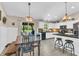 Open kitchen features white cabinetry, granite countertops, stainless steel appliances, and hardwood floors at 10174 N County Road 471 E, Pittsboro, IN 46167
