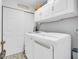 Neat laundry room with a new washer and dryer, storage cabinets, and decorative flooring at 10174 N County Road 471 E, Pittsboro, IN 46167