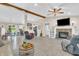 Bright living room features a fireplace, wood beam, open floorplan, and hardwood flooring at 10174 N County Road 471 E, Pittsboro, IN 46167
