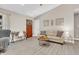 Cozy living room with neutral tones, hardwood flooring, a leather sofa, and a decorative rug at 10174 N County Road 471 E, Pittsboro, IN 46167