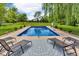 Backyard pool with lounge chairs, patio and lush landscaping at 10174 N County Road 471 E, Pittsboro, IN 46167