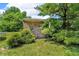 An old wooden storage shed sits among trees on a green lawn at 10174 N County Road 471 E, Pittsboro, IN 46167