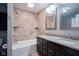 Beautifully tiled bathroom featuring a dual sink vanity, a tub, and modern fixtures at 10751 Sheffield Ct, Fishers, IN 46038