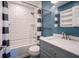 This bathroom showcases subway tile and a black and white shower curtain, plus updated vanity at 10751 Sheffield Ct, Fishers, IN 46038