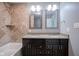 Elegant bathroom featuring a dual sink vanity, a tub, and dark wood cabinets at 10751 Sheffield Ct, Fishers, IN 46038