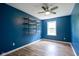 Bright bedroom featuring custom shelves, a large window, and modern fixtures at 10751 Sheffield Ct, Fishers, IN 46038