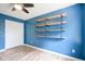 Bright bedroom featuring a wall mounted shelf, a door, and modern fixtures at 10751 Sheffield Ct, Fishers, IN 46038