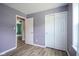 This bedroom features stylish light-gray walls and wood-look floors, complemented by white doors and trim at 10751 Sheffield Ct, Fishers, IN 46038