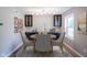 Cozy dining area with contemporary lighting, dark cabinets, and seating for four at 10751 Sheffield Ct, Fishers, IN 46038