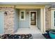 Inviting entryway with a decorative glass door, stylish brick accents, and manicured flower beds at 10751 Sheffield Ct, Fishers, IN 46038