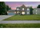 Charming two-story home with a well-maintained lawn at dusk with vibrant sky at 10751 Sheffield Ct, Fishers, IN 46038