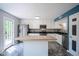 Modern kitchen featuring white cabinets, stainless steel appliances, and a center island at 10751 Sheffield Ct, Fishers, IN 46038