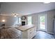Open-concept space with a cozy living area featuring a fireplace, kitchen island, and ample natural light at 10751 Sheffield Ct, Fishers, IN 46038