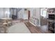 Spacious living room featuring hardwood floors, staircase, and a cozy fireplace at 10751 Sheffield Ct, Fishers, IN 46038