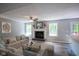 Bright living room with a cozy fireplace, a ceiling fan, and a comfortable sectional sofa at 10751 Sheffield Ct, Fishers, IN 46038