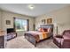 Inviting bedroom with plush carpeting, neutral walls, and a sunny window at 10917 Hunter Lake Ln, Indianapolis, IN 46239