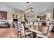 Open dining area with hardwood floors flows into the living room and features contemporary chandelier and furniture at 10917 Hunter Lake Ln, Indianapolis, IN 46239