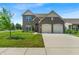Charming two-story brick home featuring a two-car garage, well-manicured lawn, and beautiful landscaping at 10917 Hunter Lake Ln, Indianapolis, IN 46239