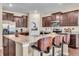 Modern kitchen featuring an island with bar seating, dark wood cabinets, and stainless steel appliances at 10917 Hunter Lake Ln, Indianapolis, IN 46239