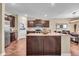 Spacious kitchen featuring granite countertops, dark wood cabinets, and stainless steel appliances at 10917 Hunter Lake Ln, Indianapolis, IN 46239