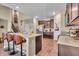Open-concept kitchen with an island, breakfast bar, stainless steel appliances, and hardwood floors at 10917 Hunter Lake Ln, Indianapolis, IN 46239