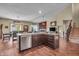 Bright, open kitchen with a center island, stainless steel appliances, and seamless flow to living area at 10917 Hunter Lake Ln, Indianapolis, IN 46239