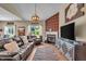 Comfortable living room featuring a decorative fireplace, hardwood flooring, and natural lighting at 10917 Hunter Lake Ln, Indianapolis, IN 46239