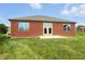 Brick house featuring a walkout patio and verdant lawn, perfect for enjoying outdoor living at 1127 Kay Dr, Greenwood, IN 46142