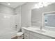 Bright bathroom with a marble countertop vanity, white cabinets, and a shower-tub combination at 1127 Kay Dr, Greenwood, IN 46142