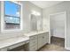Bathroom featuring a marble countertop vanity, ample natural light, and a view to the outside at 1127 Kay Dr, Greenwood, IN 46142