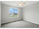 Bright bedroom with a ceiling fan and large window overlooking the neighborhood, creating a comfortable and serene space at 1127 Kay Dr, Greenwood, IN 46142