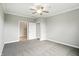 Spacious bedroom with neutral carpet, ceiling fan, and white doors leading to another room and closet at 1127 Kay Dr, Greenwood, IN 46142