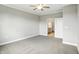 Inviting bedroom featuring neutral carpet, a ceiling fan, and access to a bathroom and closet at 1127 Kay Dr, Greenwood, IN 46142