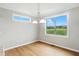 Cozy dining area with hardwood floors, bright window, and stylish light fixture at 1127 Kay Dr, Greenwood, IN 46142