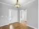 Inviting foyer with hardwood floors, gray walls, and a bright entryway door and classic pendant lighting at 1127 Kay Dr, Greenwood, IN 46142