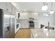 Well-equipped kitchen with stainless steel appliances, granite countertops, and pristine white cabinets, offering a sleek design at 1127 Kay Dr, Greenwood, IN 46142