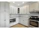 This modern kitchen corner features stainless steel appliances, granite countertops, and white cabinets, designed for style and function at 1127 Kay Dr, Greenwood, IN 46142