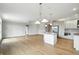 Bright, open kitchen and living space featuring hardwood floors and a large center island, ideal for cooking and gathering at 1127 Kay Dr, Greenwood, IN 46142