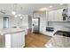 Modern kitchen features stainless steel appliances, granite countertops, and ample white cabinetry, a chef's dream come true at 1127 Kay Dr, Greenwood, IN 46142