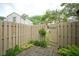 This backyard offers a wood fence, patio, and green space at 11624 Buttonwood Dr, Carmel, IN 46033