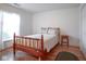 This bedroom features a wood frame bed, wood floors, and large window at 11624 Buttonwood Dr, Carmel, IN 46033